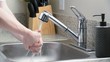 Man leaves kitchen sink faucet running after washing hands