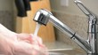 Close up of man washing hands in kitchen sink