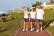 active healthy family walking by the beach