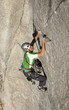 Climber scales a cliff.