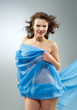 Beautiful woman in  waving fabric.
