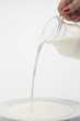 pouring of milk from jug into a ...