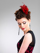 Photo: Woman with fashion hairstyle with red feather in hairs Woman with fashion hairstyle with red feather in hairs