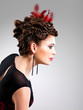Photo: Woman with fashion hairstyle with red feather in hairs Woman with fashion hairstyle with red feather in hairs