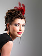 Photo: Woman with fashion hairstyle with red feather in hairs Woman with fashion hairstyle with red feather in hairs