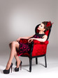 Photo: Woman with fashion hairstyle and red armchair Woman with fashion hairstyle and red armchair