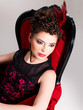 Photo: Woman with fashion hairstyle and red armchair Woman with fashion hairstyle and red armchair
