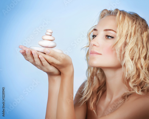 Photo: Cute woman with spa stones Cute woman with spa stones