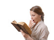 yawning girl reading a boring book, isolated on white