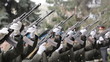 An honor guard fires a gun salute.
