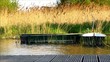 Two small green rowboats in a lake