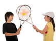 two happy children posing with tennis racquets on white backgrou