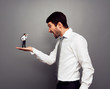 boss screaming at the small man with megaphone