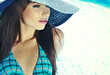 Beautiful young sexy woman by a swimming pool