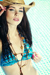 Beautiful young sexy woman by a swimming pool