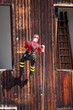 Fireman in uniform by climber and rock climber while descending