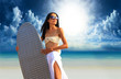 surfer girl with surfboard at a beach