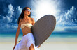 surfer girl with surfboard at a beach