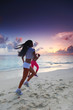 Two women running on beach
