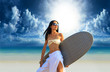 surfer girl with surfboard at a beach