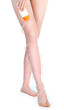 Woman putting lotion on legs