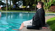 Video: Young businessman listen to music and relaxing by the pool Young businessman listen to music and relaxing by the pool