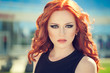 Summer portrait of beautiful woman with red hair and smoky eyes