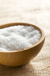 white salt in wooden bowl