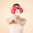 woman holding bouquet of flowers over her face