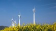 wind turbines row spinning over spring field