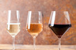 Three goblets with many types of wine.