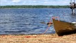 White rowboat laying on a beach