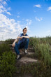 a young man sitting on the steps of the old