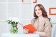 Portrait of a beautiful woman with a book