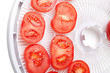 Fresh tomato on food dehydrator tray