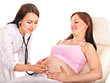Pregnant woman with doctor .