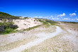 path in sand dunes over blue sky