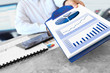 Businessman Showing Financial Charts on the Clipboard