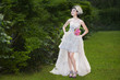 Photo: Beautiful bride in wedding gown at park Beautiful bride in wedding gown at park