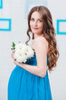 Portrait of a pregnant woman with flowers
