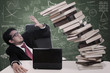 Photo: Stress businessman with falling books at class Stress businessman with falling books at class