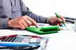 Foto: Hand of a businessman with calculator. Hand of a businessman with calculator.