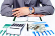 Photo: Hand with calculator and money. Hand with calculator and money.