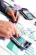Photo: Hand with calculator and money. Hand with calculator and money.