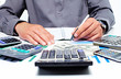 Hand with calculator and money.