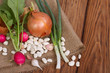 onion, radishes, beans, garlic on a wooden table