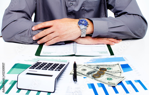 Photo: Hand with calculator and money. Hand with calculator and money.