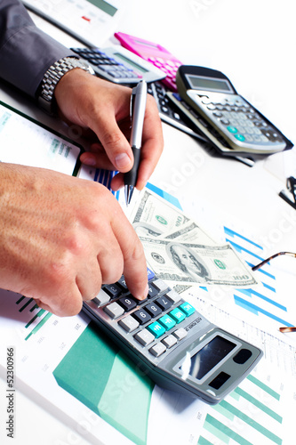 Photo: Hand with calculator and money. Hand with calculator and money.
