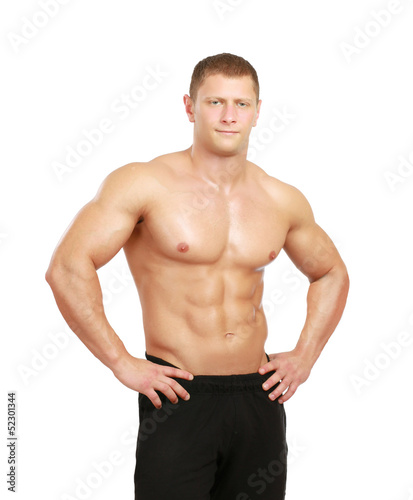 Photo: Healthy muscular young man. Isolated on white background Healthy muscular young man. Isolated on white background