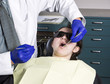 Photo: Dentist getting ready to do examination on teeth on young girl Dentist getting ready to do examination on teeth on young girl